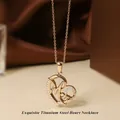 Golden titanium steel heart necklace with zircon inlay and artistic MG letters - Rose Gold Heart Necklace N0454R