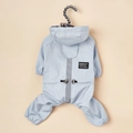 Close-up of a light blue waterproof pet raincoat featuring reflective safety stripes - Four-legged Reflective Raincoat - Blue