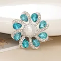 Detailed view of 4cm floral brooch with blue crystals and large central pearl inlay - D2021 Teardrop Gemstone Flower (Blue)