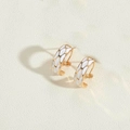 Close-up of gold-plated hoop earrings with white enamel honeycomb pattern detail - White