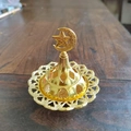 Close-up of golden Middle Eastern incense burner with hollow geometric patterns and star moon lid - Star and Moon Top