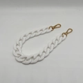 Close-up of white acrylic resin chain strap with polished gold lobster clasps - White
