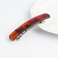 Minimalist tortoiseshell hair clip with premium acetate finish on a white ceramic plate - Square Style / Glossy Red Tortoise