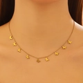 Close-up of gold butterfly necklace with nine matte brushed pendants on model - Gold Butterfly