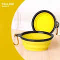 Collapsible yellow TPE pet bowl for travel with a black rim and metal carabiner clip - Yellow