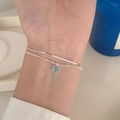 Close-up of double-layer silver bracelet with snake chain and light blue round pendant - Silver Double Snake Light Blue Pendant (MY35312)