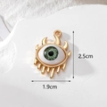 Detailed size view of a 2.5cm green evil eye pendant with gold plating on marble background - Horn Green Eye