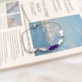 Silver chain bracelet with five fish charms featuring one purple accent fish charm - Purple Fish Upstream Bracelet