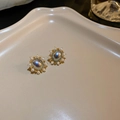 Detail view of vintage gold earrings with oval opal stones and pearl accents - Gold Oval Magic Gem Pearl Style