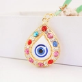 Golden teardrop evil eye charm with colorful rhinestones and blue central jewel - Gold