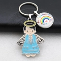Detail view of silver angel pendant and Schulkind rainbow charm keychain on leather - Lake Blue