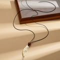 Detail view of a gold leaf pendant necklace with wood bead and black cord chain - Gold Leaf (HN10736) / Gold
