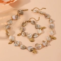 Detail of stainless steel necklace and bracelet set with shell and seahorse pendants - Shell Set