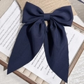 Elegant navy blue fabric bow hair clip with long ribbons on a decorative display tray - Navy Print Ribbon