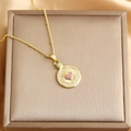 Gold plated necklace with a round pendant featuring a pink zircon heart inlay - Gold (Pink Zircon)