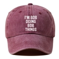 Detail of burgundy washed cotton baseball cap with I'M BOB DOING BOB THINGS text - Adjustable / Burgundy