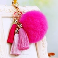 Detail of pink faux fur pompom keychain with gradient tassels on gold lobster clasp - Rose Red