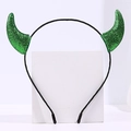 Detailed macro view of green glittery devil horns on a slim black Halloween headband - Green Glitter Devil Horn Headband / 12 Pcs/Bag