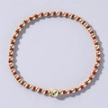 Elastic beaded bracelet featuring a mix of glossy red and metallic gold beads - Shiny Red and Gold