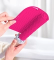 Red heat-resistant silicone mat with wave texture wrapping a hair styling tool - Rose Red
