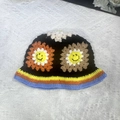 Handmade black knit bucket hat with colorful floral patterns and sunflower crochet details - M (56-58cm) / Rainbow Smiley Flower