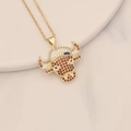 Detailed view of bull head pendant with zircon stones on marble surface background - Red & White Gems Splicing Bull Head Style (14#)