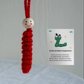 Handmade red crochet worry worm with smiling wood bead and German message card - Red Lucky Worm