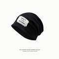 Women's black slouchy knit beanie featuring a season-themed woven label and soft fabric - Letter Patch Style / Black