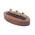 Golden heart rings with pink, purple, and green gems on walnut wood display stand - Grey Velvet