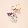 Glittering purple resin letter S keychain with tassel and gold hardware for bags - Letter S