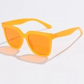 Detail view of stylish orange oversized square sunglasses with translucent frames - Jelly Orange