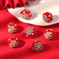 Detailed view of red handcrafted ceramic beads with traditional blue cloud patterns for DIY - Blue Pattern / Red