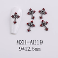 Macro view of gothic black metal cross nail charms with red rhinestones and heart detail - Red Stone Cross (AE19)