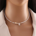 Detail of shell letter E necklace with white crystal beads and gold heart pendant - Letter E