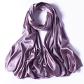 Detailed view of the smooth glossy texture of a purple satin scarf on a white background - Lilac Purple