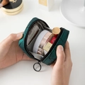 Portable mini makeup bag in dark green quilted fabric showing interior storage space - Leather Green