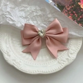 Elegant pink satin double bow hair claw with a heart-shaped rhinestone on a white plate - White Satin Heart Rhinestone Style / White Bangs Rhinestone Side Clip