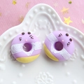 Detailed view of purple resin cat-faced donuts on a white porcelain relief plate - Purple Base