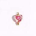 Close-up of pink heart-shaped glass bead with red inner heart and gold accents - Clear Pink Base Layered Red Hearts (Style 10)