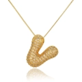 Close-up of golden bubble letter L pendant necklace paved with sparkling zircons - Letter V (D1079-V)
