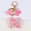 Glitter resin letter N keychain with butterfly pendant and pink leather tassel accessory - Letter N