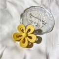 Elegant matte yellow flower hair claw clip with cutout petals on a white textured background - Matte Yellow