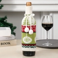 Green and red knitted Christmas wine bottle cover with tree pattern and white pom poms - Christmas Tree