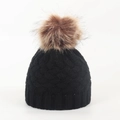 Detail of black knit baby winter hat featuring a large brown faux fur pom pom - 0-12 Months / Black