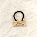 Minimalist gold metal knot hair tie with black elastic band on white background - Gold Crossed Liquid 5cm