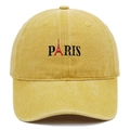 Macro detail of embroidered Paris logo and Eiffel Tower on yellow washed baseball cap - Yellow