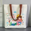 Cream canvas tote bag with brown straps featuring a cartoon girl travel illustration - More Effort More Luck-EN