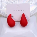 Pair of chunky water drop earrings in matte red finish on a white jewelry card - Red