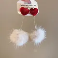 Detailed view of heart-shaped plush ball earrings with S925 silver needles - Red Heart White Pom-pom (Long Dangle Style)