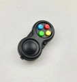 Close-up of stress relief game controller toy with colorful silicone buttons on white background - Black with Colorful Buttons, Color Box and String